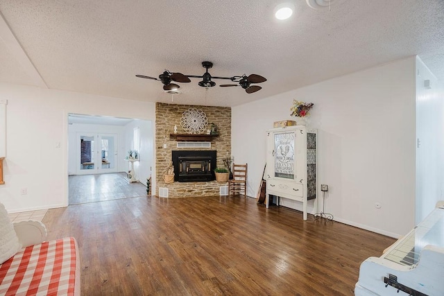 living room with french doors, a textured ceiling, a ceiling fan, and wood finished floors