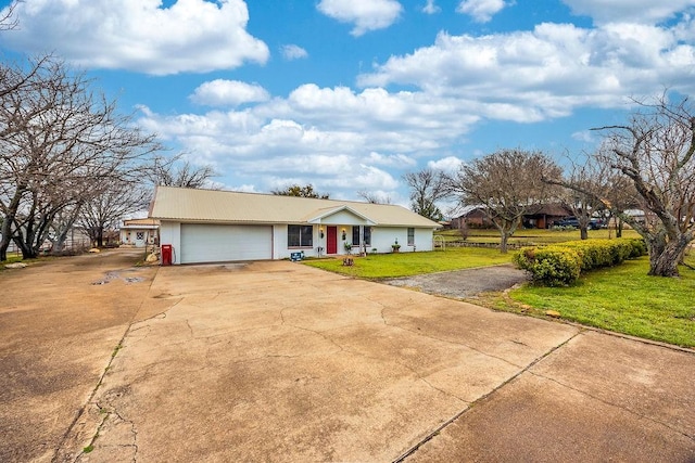 ranch-style house with a garage, concrete driveway, and a front yard