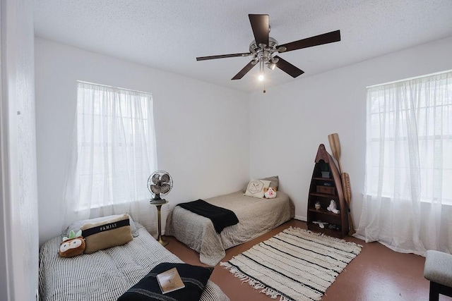 bedroom with a textured ceiling and a ceiling fan