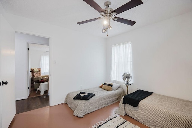 bedroom with a ceiling fan and wood finished floors