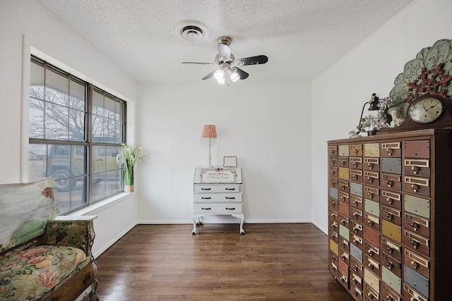 sitting room with visible vents, baseboards, a textured ceiling, and wood finished floors