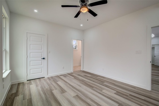 empty room with ceiling fan, recessed lighting, light wood-style flooring, and baseboards