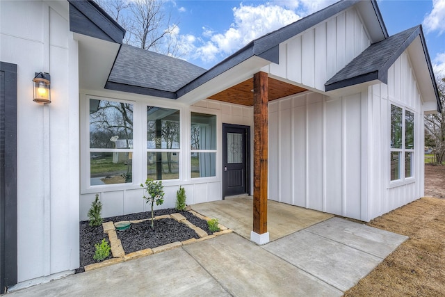 entrance to property with board and batten siding and roof with shingles