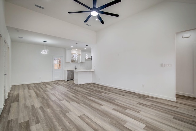 unfurnished living room featuring light wood-style floors, baseboards, and visible vents