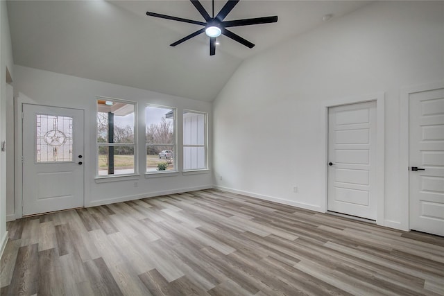 unfurnished living room featuring high vaulted ceiling, ceiling fan, baseboards, and wood finished floors