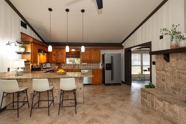 kitchen featuring open shelves, stainless steel appliances, arched walkways, a peninsula, and light stone countertops