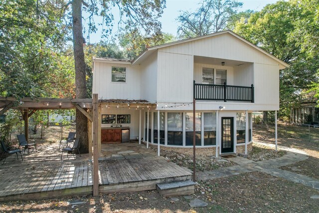 rear view of house featuring a balcony