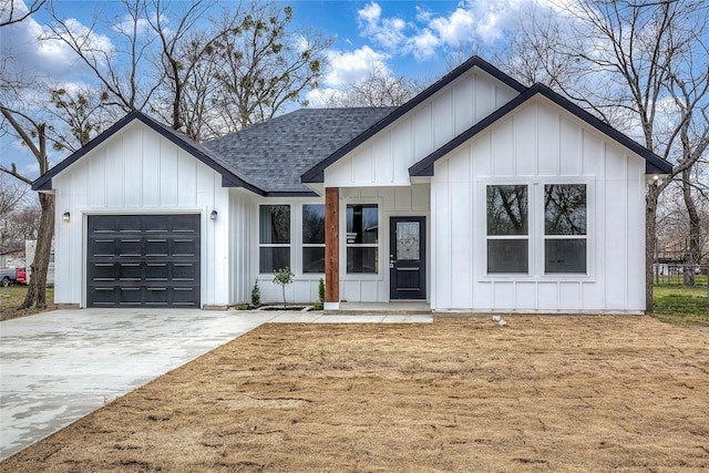 modern farmhouse style home featuring a garage, driveway, board and batten siding, and roof with shingles