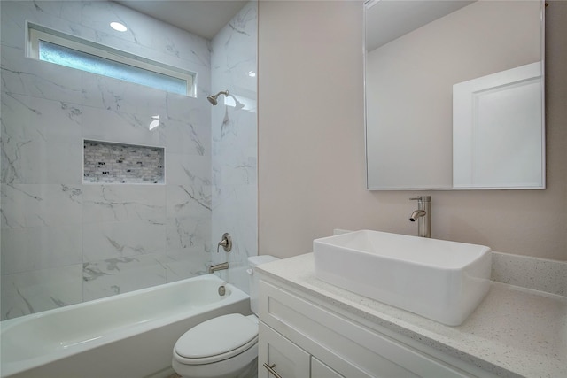 bathroom with bathtub / shower combination, vanity, and toilet