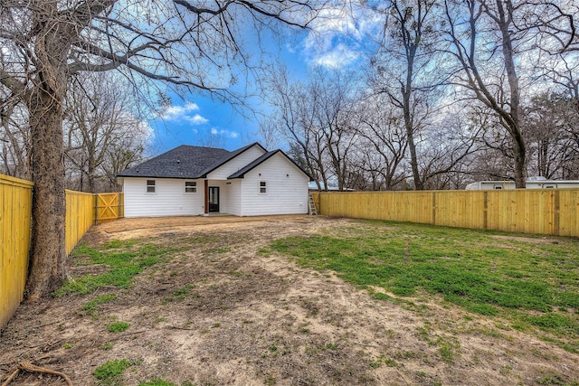 back of property with a fenced backyard