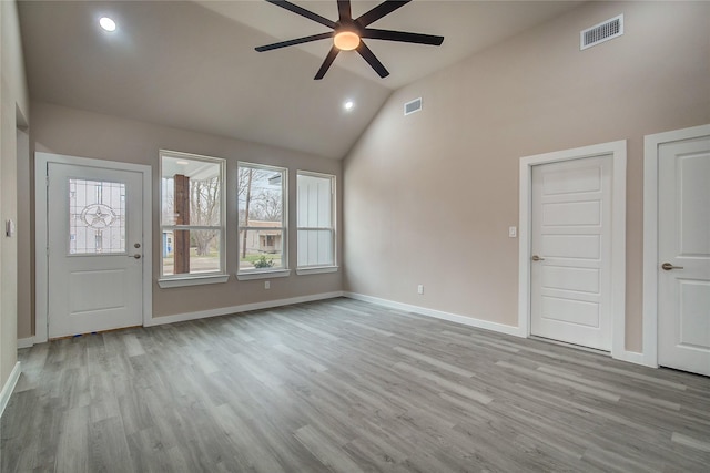 unfurnished living room with a ceiling fan, wood finished floors, visible vents, and baseboards