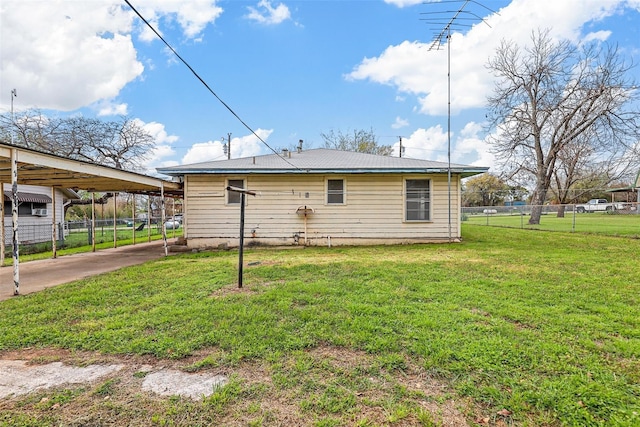 back of property with a lawn and fence