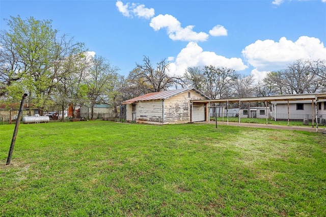 view of yard featuring a garage and fence