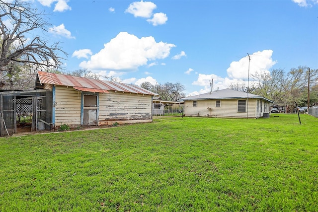 view of yard with an outdoor structure and fence