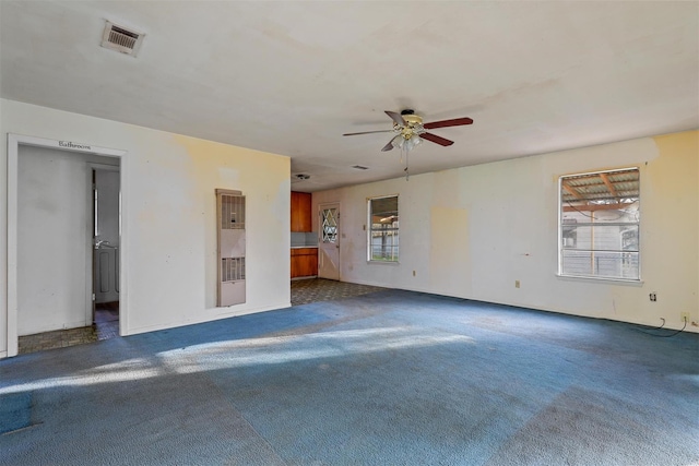 unfurnished living room featuring a ceiling fan, carpet, and visible vents