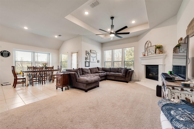 215 Tallgrass Dr, Lavon, TX 75166 - living area with ceiling fan, a glass covered fireplace, recessed lighting, a tray ceiling, and light tile patterned floors