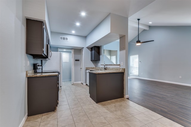 kitchen with visible vents, baseboards, a ceiling fan, dark brown cabinets, and range