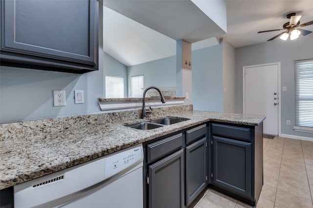 kitchen featuring light tile patterned flooring, a sink, light stone countertops, dishwasher, and a peninsula