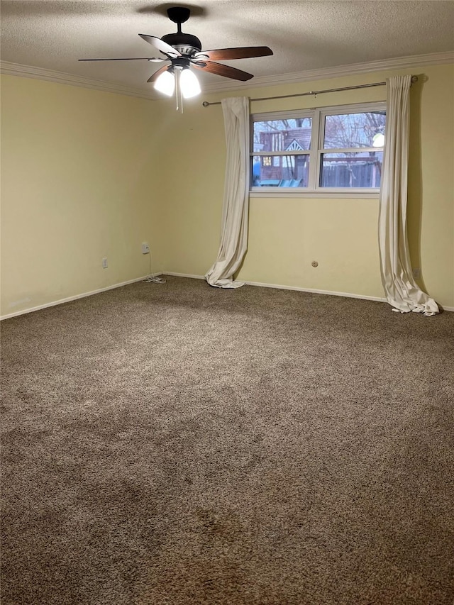 carpeted spare room with a ceiling fan, crown molding, a textured ceiling, and baseboards