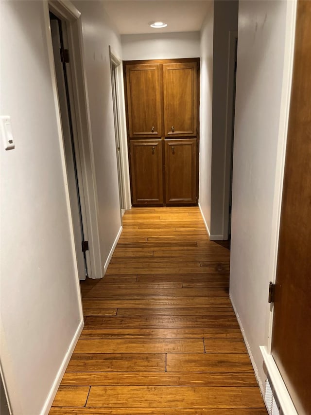 hall with hardwood / wood-style floors, recessed lighting, and baseboards