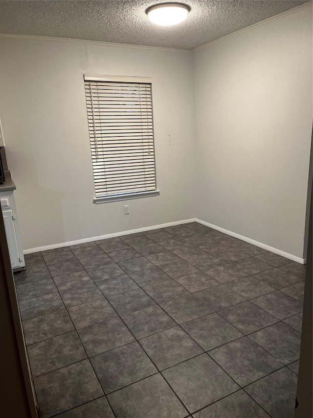 spare room featuring crown molding, a textured ceiling, and baseboards