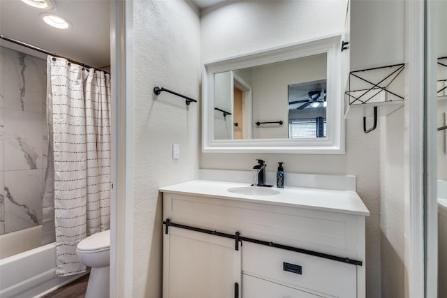 full bath featuring a ceiling fan, a textured wall, toilet, shower / bath combination with curtain, and vanity