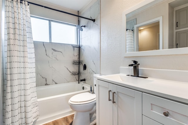 bathroom featuring a textured wall, toilet, wood finished floors, vanity, and shower / bath combo