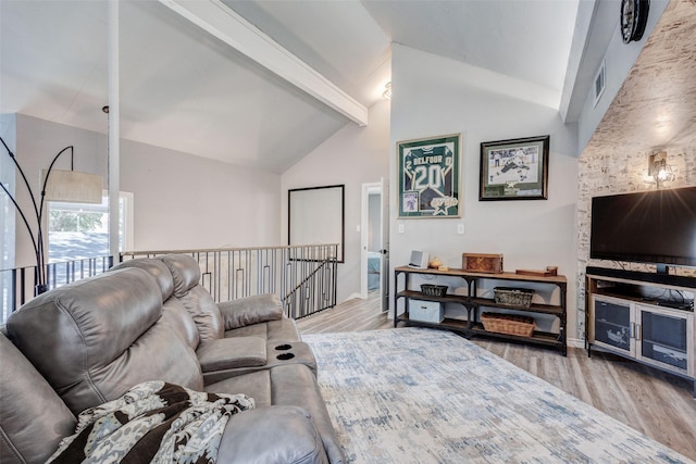 living area featuring high vaulted ceiling, beamed ceiling, wood finished floors, and visible vents