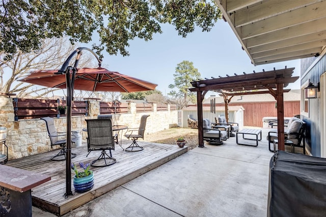 view of patio with a fenced backyard, outdoor dining area, and a wooden deck