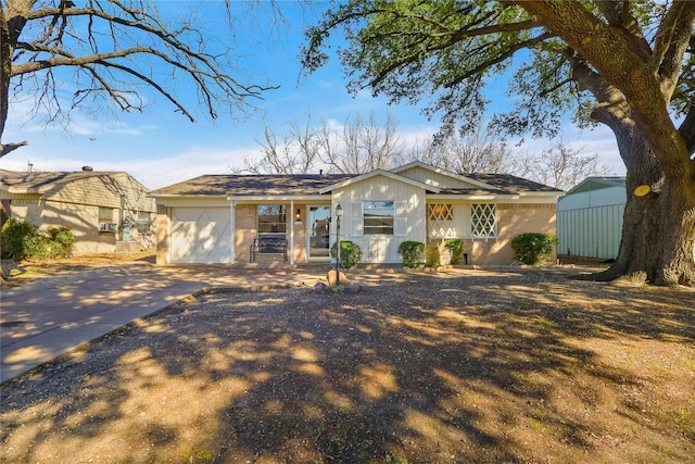 ranch-style home featuring a garage and driveway