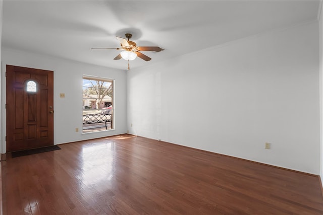 foyer with ceiling fan, crown molding, and wood finished floors