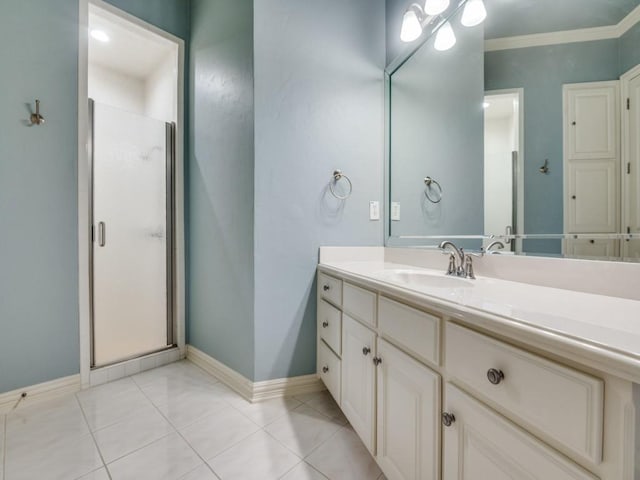 full bathroom with a shower stall, baseboards, crown molding, and vanity