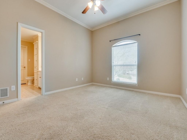 carpeted spare room featuring baseboards, visible vents, ceiling fan, and ornamental molding