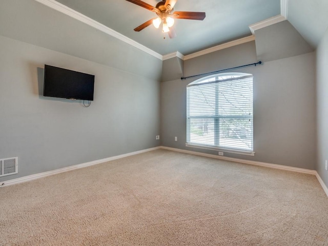 empty room featuring crown molding, carpet flooring, visible vents, and baseboards