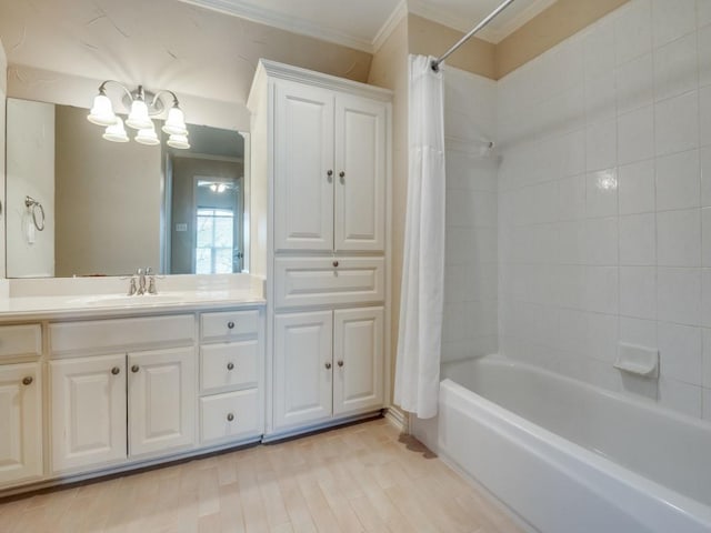 full bath with wood finished floors, shower / tub combo with curtain, crown molding, vanity, and a notable chandelier