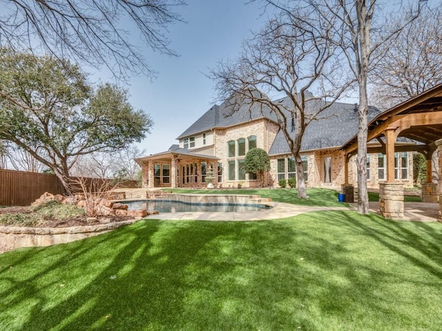 back of house with a yard, fence, a fenced in pool, and brick siding