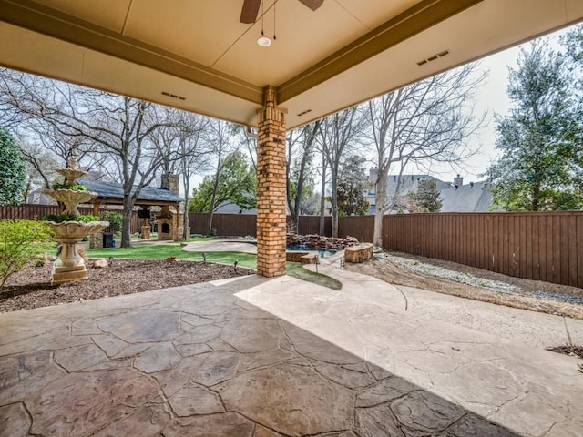 view of patio with a fenced backyard and ceiling fan