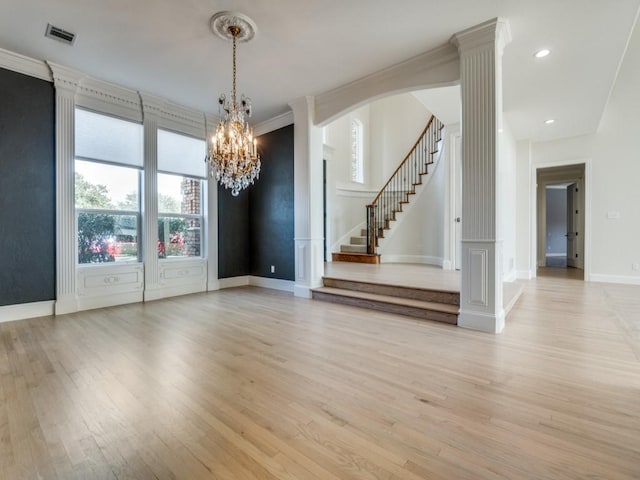 unfurnished room featuring light wood finished floors, baseboards, visible vents, stairway, and recessed lighting