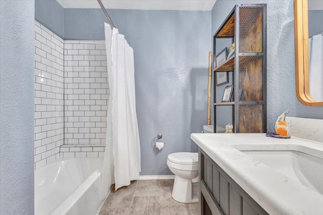 bathroom with a textured wall, toilet, shower / bath combo, vanity, and baseboards