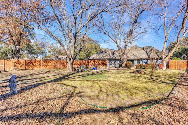 view of yard with a fenced backyard