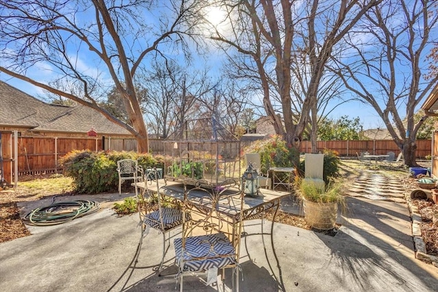 view of patio with a fenced backyard and outdoor dining area