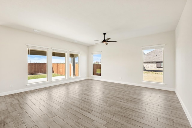 207 Cortese Ln, Alvarado, TX 76009 - unfurnished room featuring baseboards, a ceiling fan, plenty of natural light, and wood finished floors