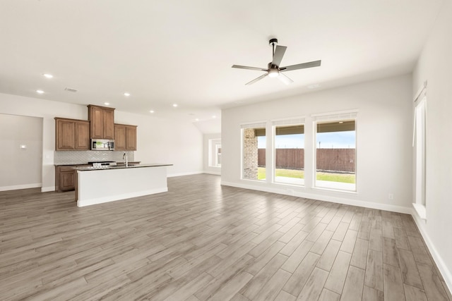 207 Cortese Ln, Alvarado, TX 76009 - unfurnished living room with recessed lighting, light wood-style floors, baseboards, and ceiling fan