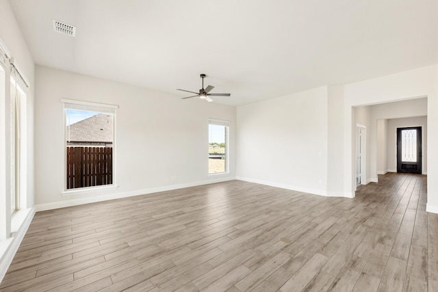 207 Cortese Ln, Alvarado, TX 76009 - spare room with visible vents, baseboards, a ceiling fan, and light wood-style flooring