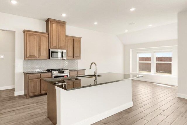 207 Cortese Ln, Alvarado, TX 76009 - kitchen with tasteful backsplash, baseboards, light wood-style floors, stainless steel appliances, and a sink