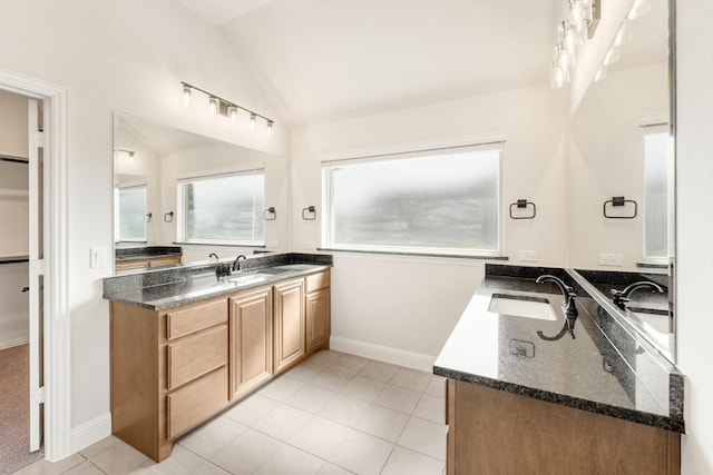207 Cortese Ln, Alvarado, TX 76009 - full bathroom with tile patterned floors, two vanities, a sink, and lofted ceiling