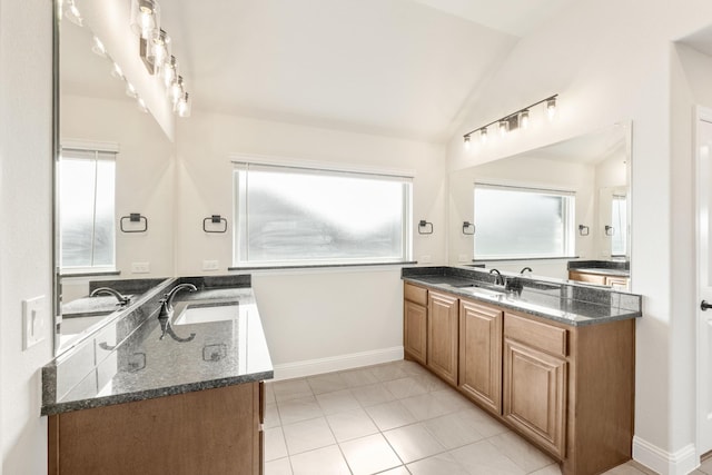 207 Cortese Ln, Alvarado, TX 76009 - bathroom featuring baseboards, tile patterned flooring, vaulted ceiling, and a wealth of natural light