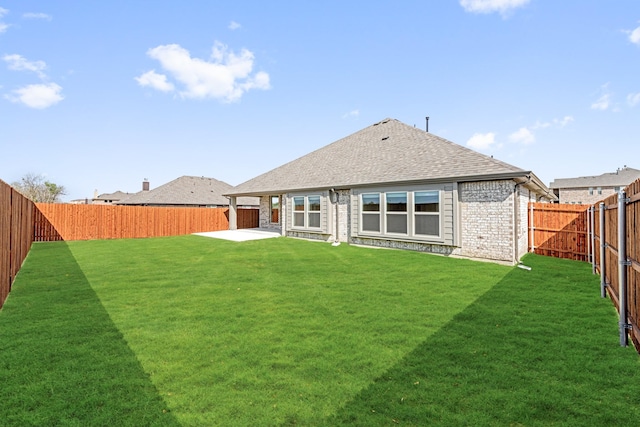 207 Cortese Ln, Alvarado, TX 76009 - back of property with a patio, roof with shingles, brick siding, a fenced backyard, and a yard