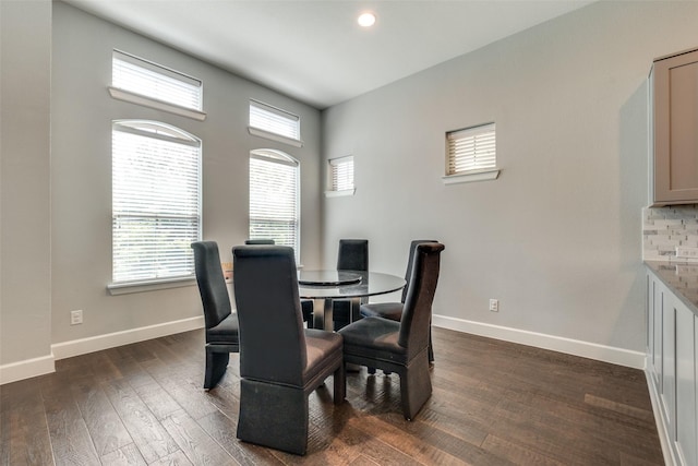 dining room with dark wood-type flooring, recessed lighting, and baseboards