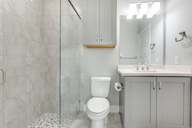 bathroom featuring a stall shower, vanity, toilet, and baseboards